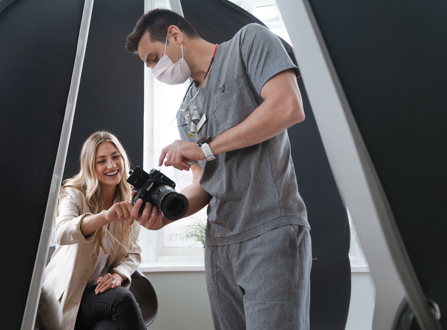 Dr Daniel Hargitai showing a patient her smile photos at Bespoke Dental, Malahide