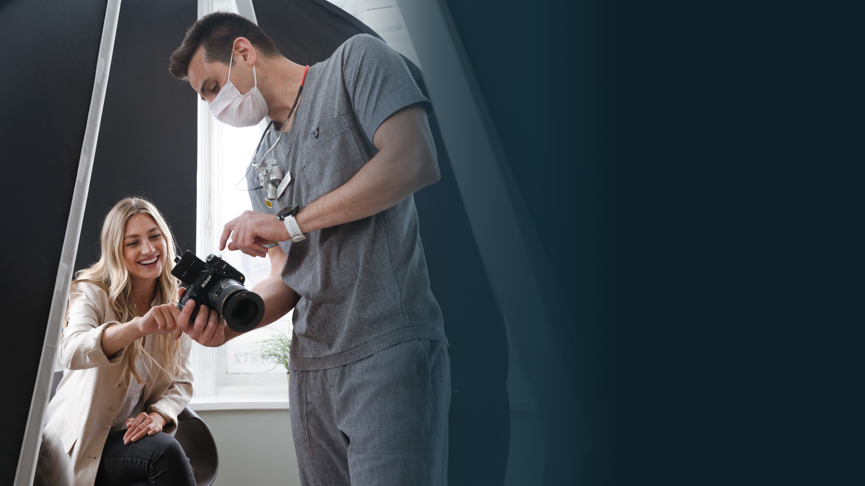 Dr Daniel Hargitai showing a patient her smile photos at Bespoke Dental, Malahide