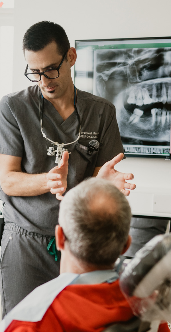 Dr Daniel Hargitai discussing dental implant treatment with a patient